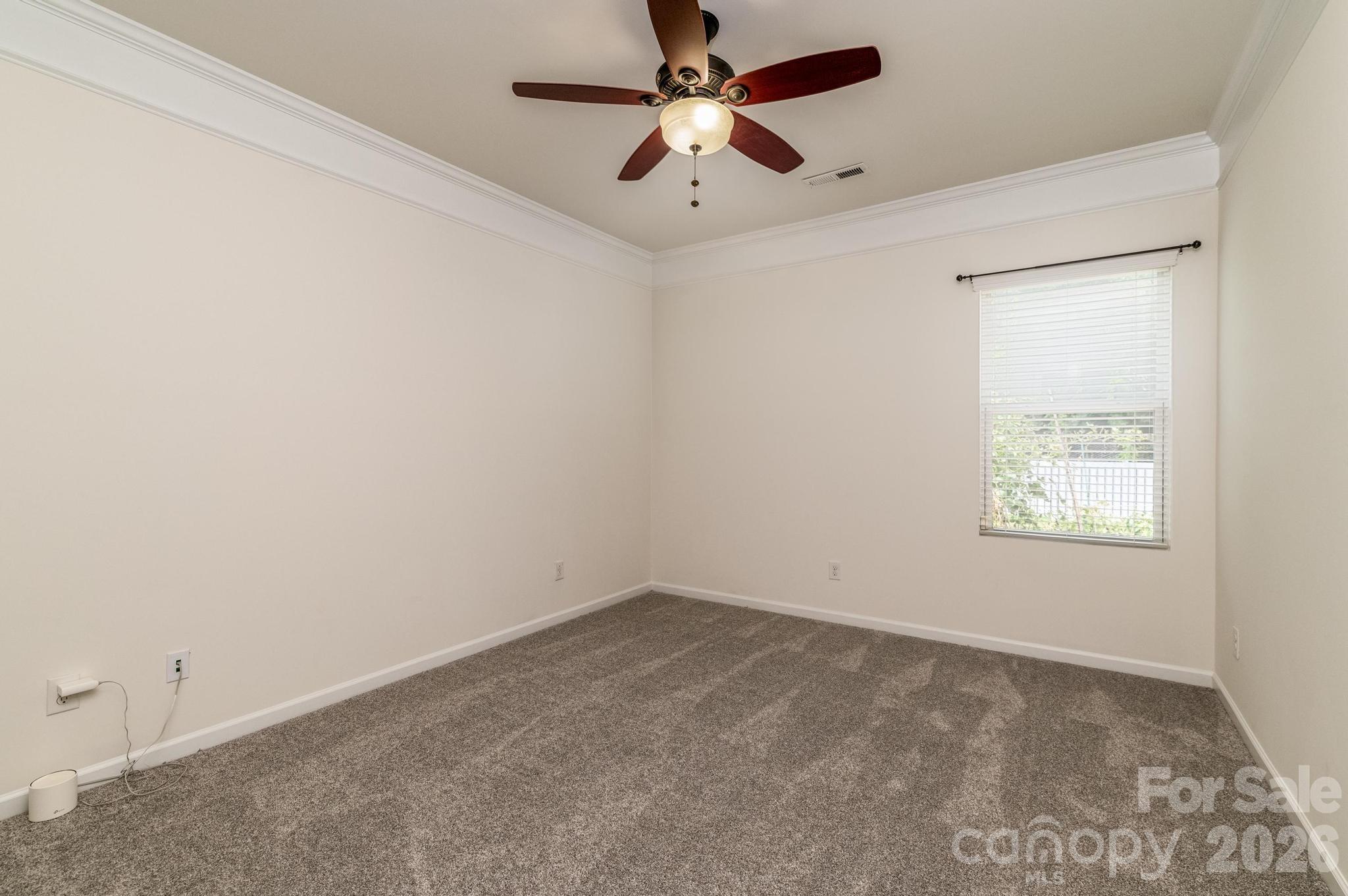 8212 Ruby Valley Road Charlotte, NC 28277 - Photo 22 of 40 an empty room with a window and a fan