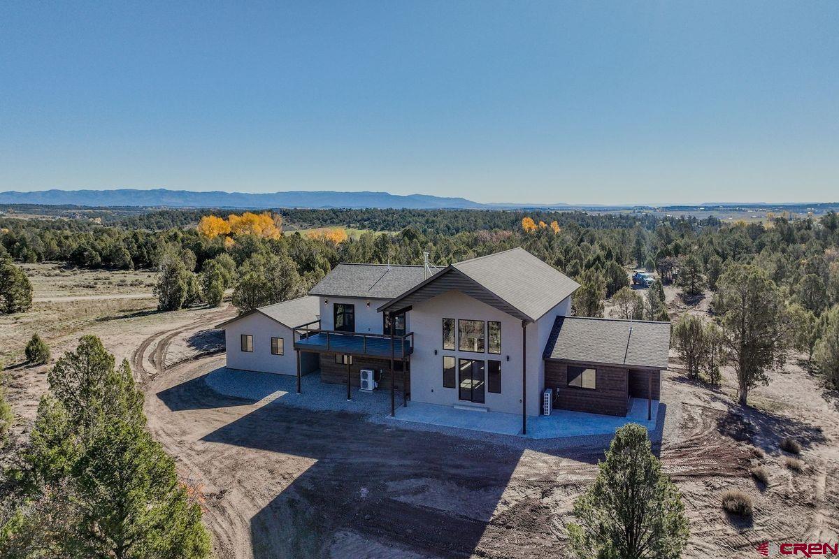 a view of house with yard outdoor seating and mountain in the background