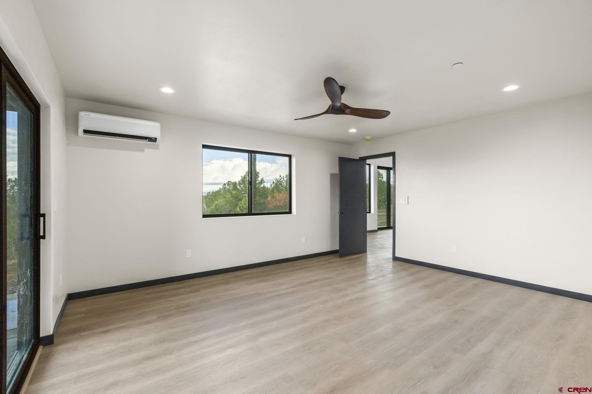 192 Rawhide Road Durango, CO 81303 - Photo 12 of 41 a view of an empty room with window and wooden floor