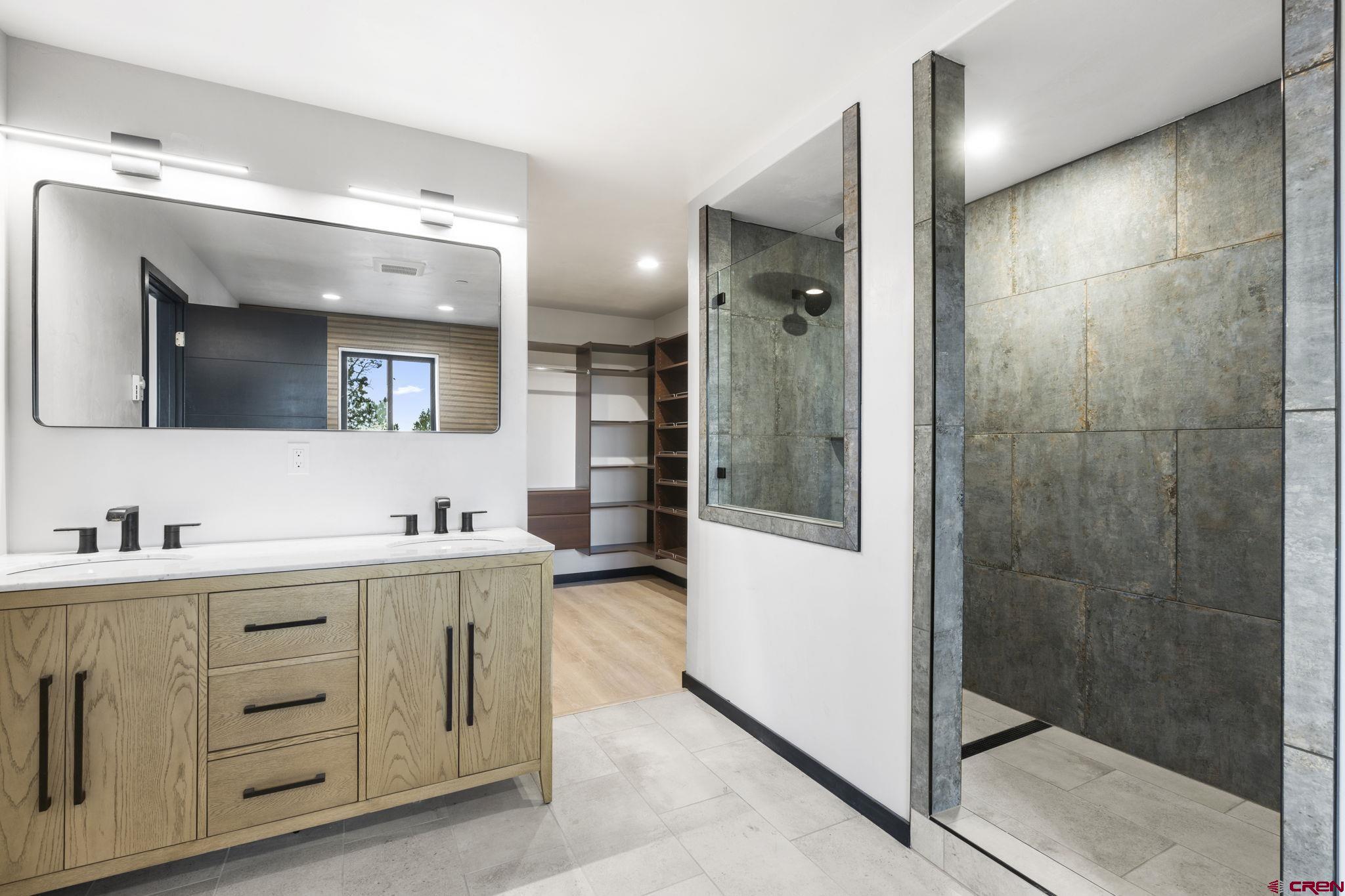 192 Rawhide Road Durango, CO 81303 - Photo 15 of 41 a bathroom with a double vanity sink mirror and shower