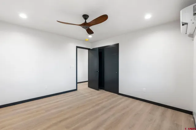 a view of empty room with wooden floor