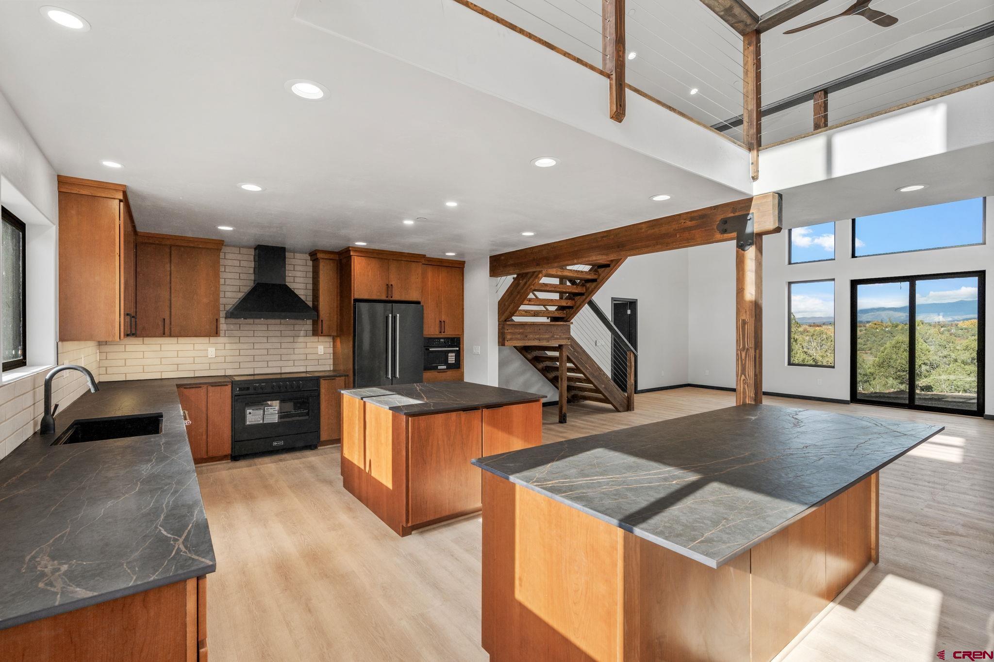 192 Rawhide Road Durango, CO 81303 - Photo 3 of 41 a kitchen with stainless steel appliances granite countertop a sink a stove and a wooden floors