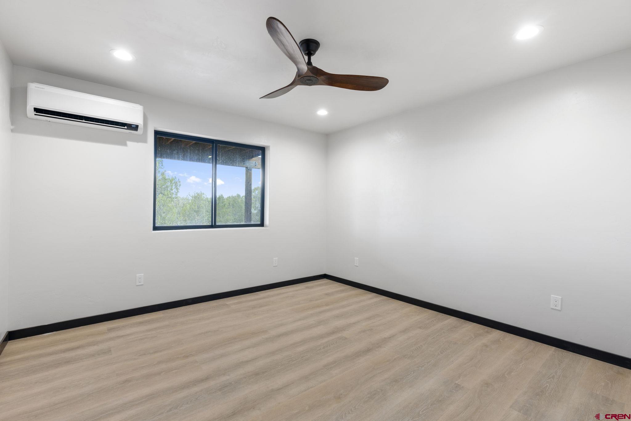 192 Rawhide Road Durango, CO 81303 - Photo 31 of 41 an empty room with wooden floor and windows