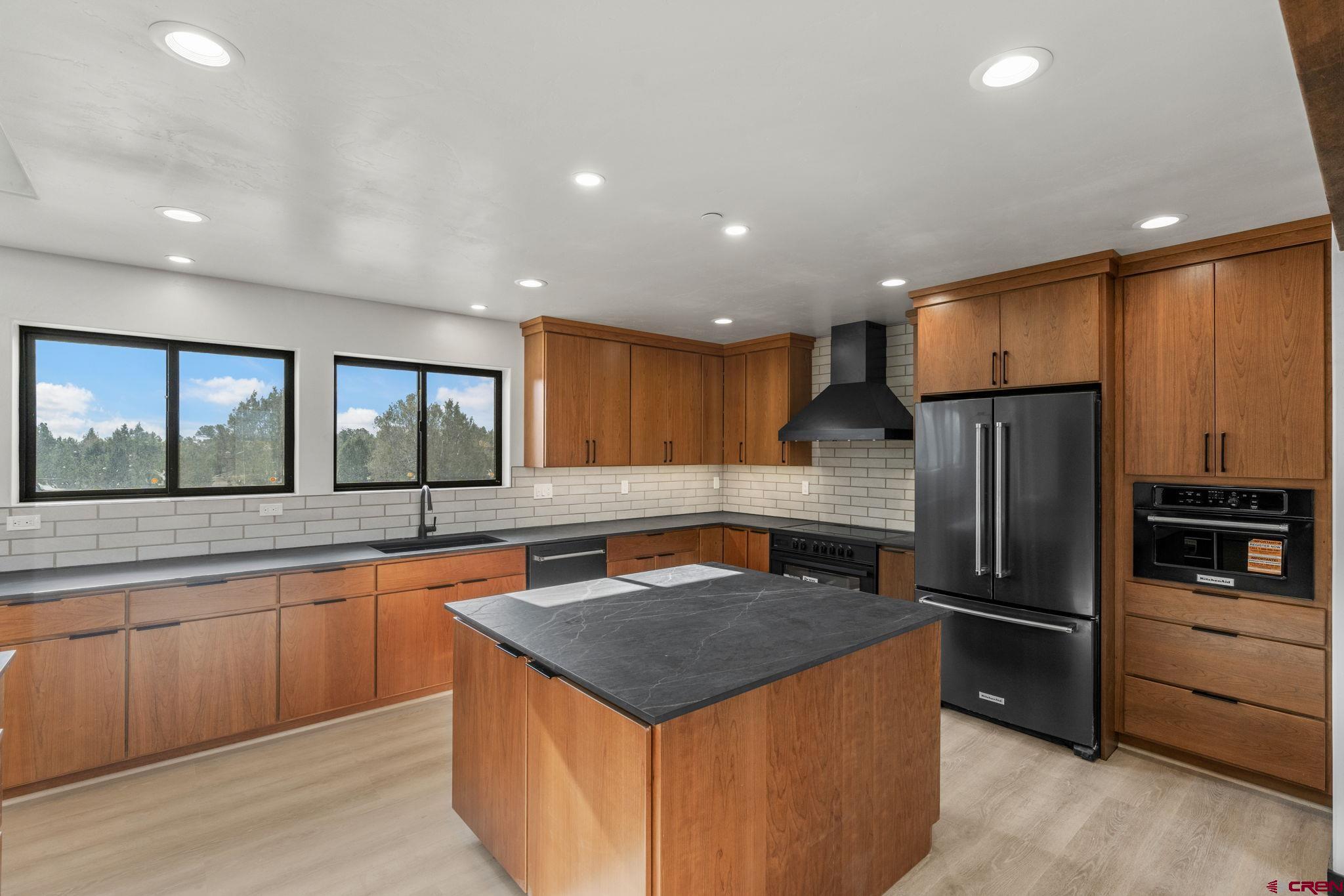 192 Rawhide Road Durango, CO 81303 - Photo 4 of 41 a kitchen with stainless steel appliances granite countertop a sink a stove a refrigerator and a microwave