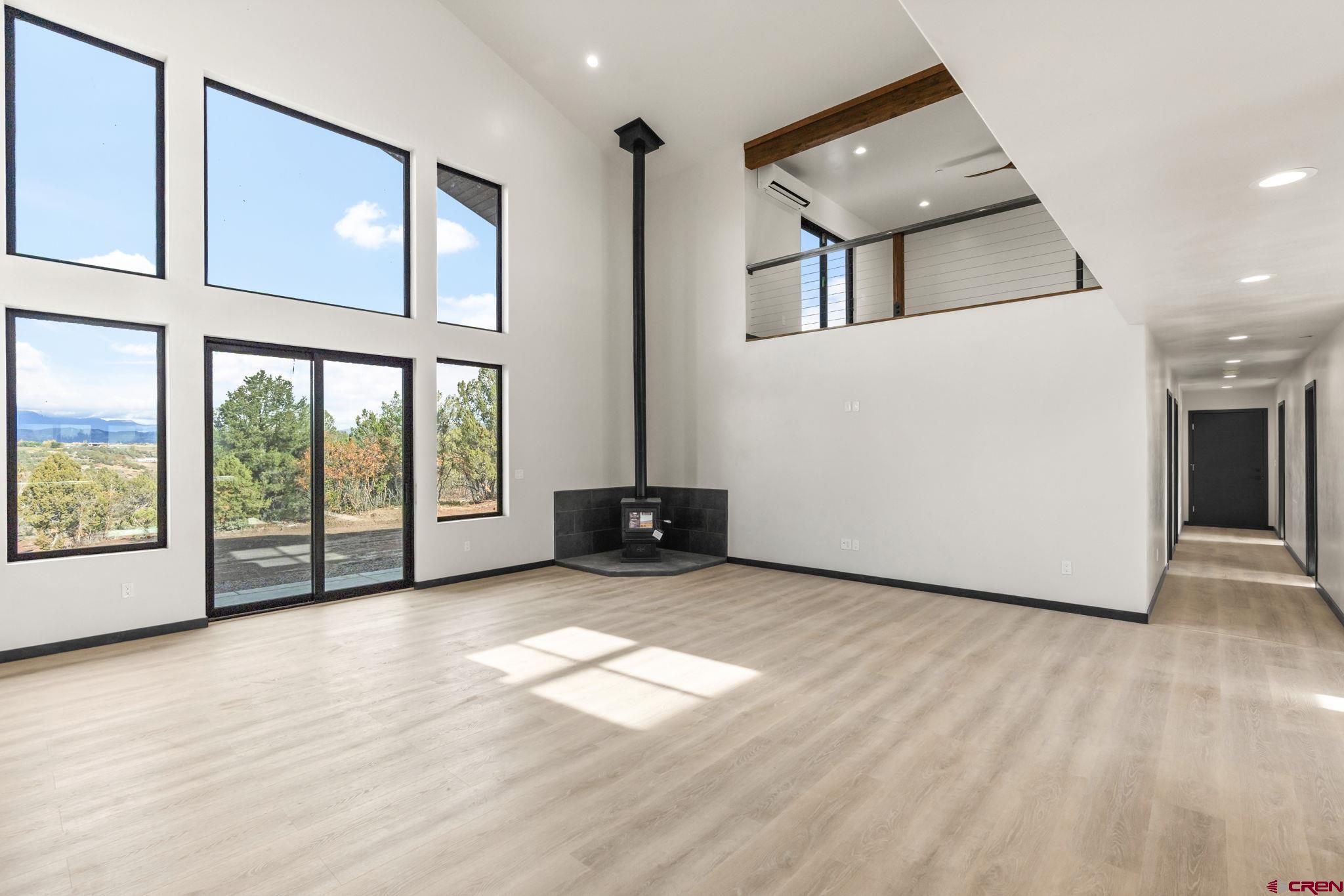 192 Rawhide Road Durango, CO 81303 - Photo 9 of 41 a view of an empty room with a window and wooden floor