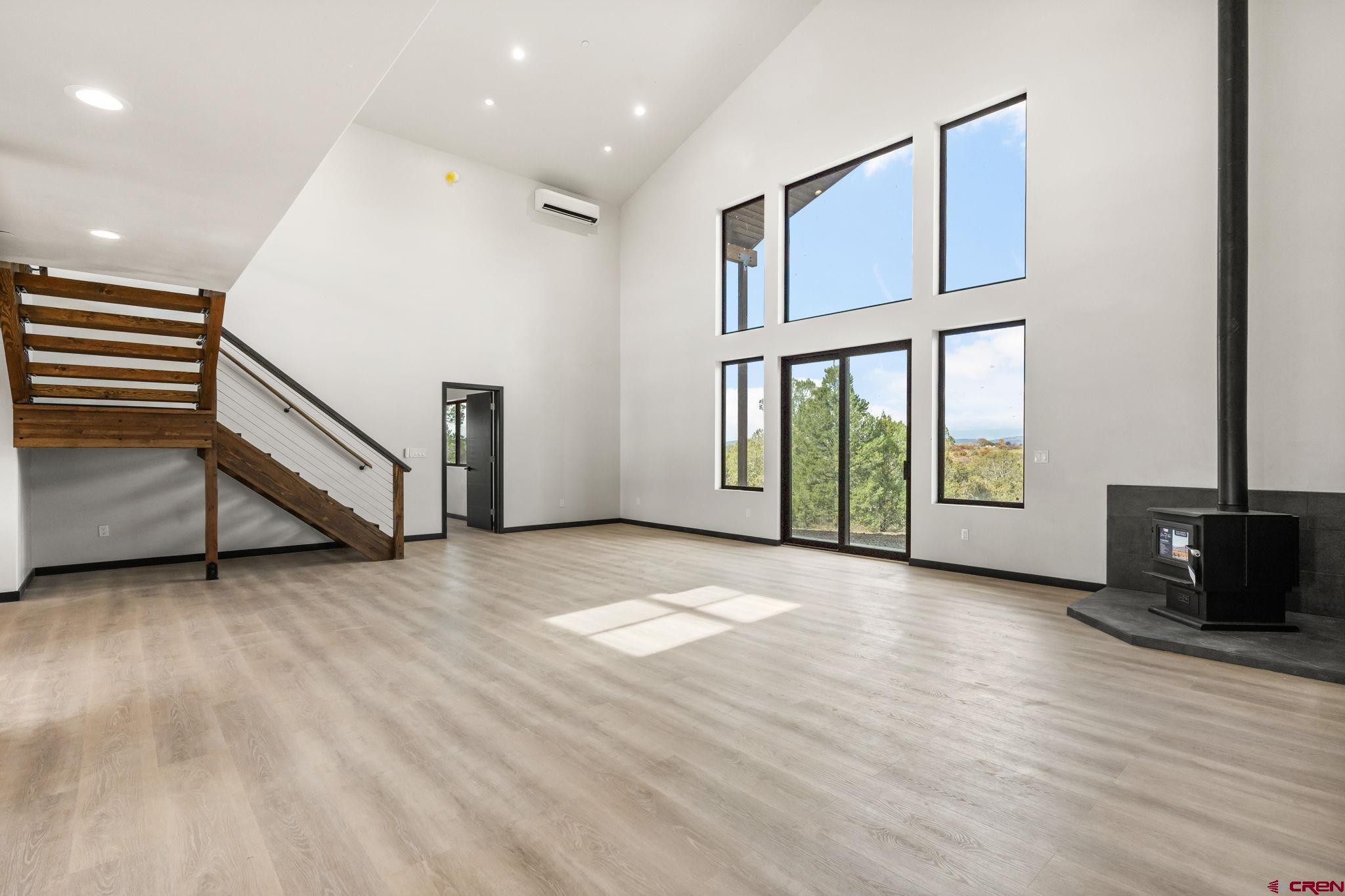 192 Rawhide Road Durango, CO 81303 - Photo 10 of 41 a view of an empty room with wooden floor and a window