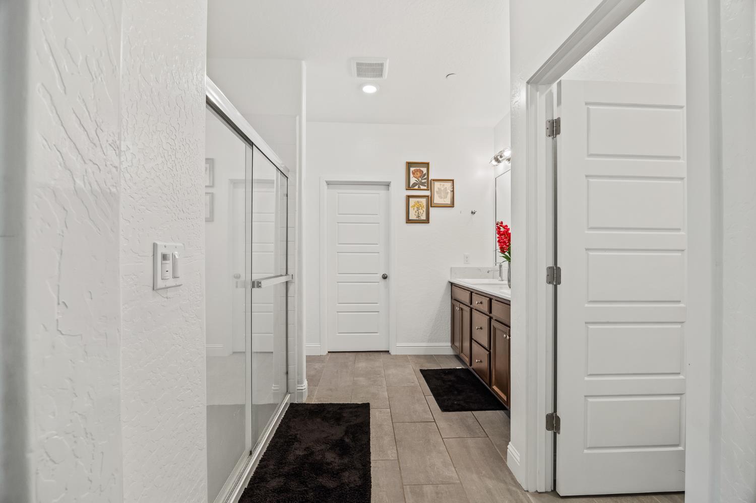 153 Boulder Drive Madera, CA 93636 - Photo 12 of 32 a hallway with cabinets and wooden floor