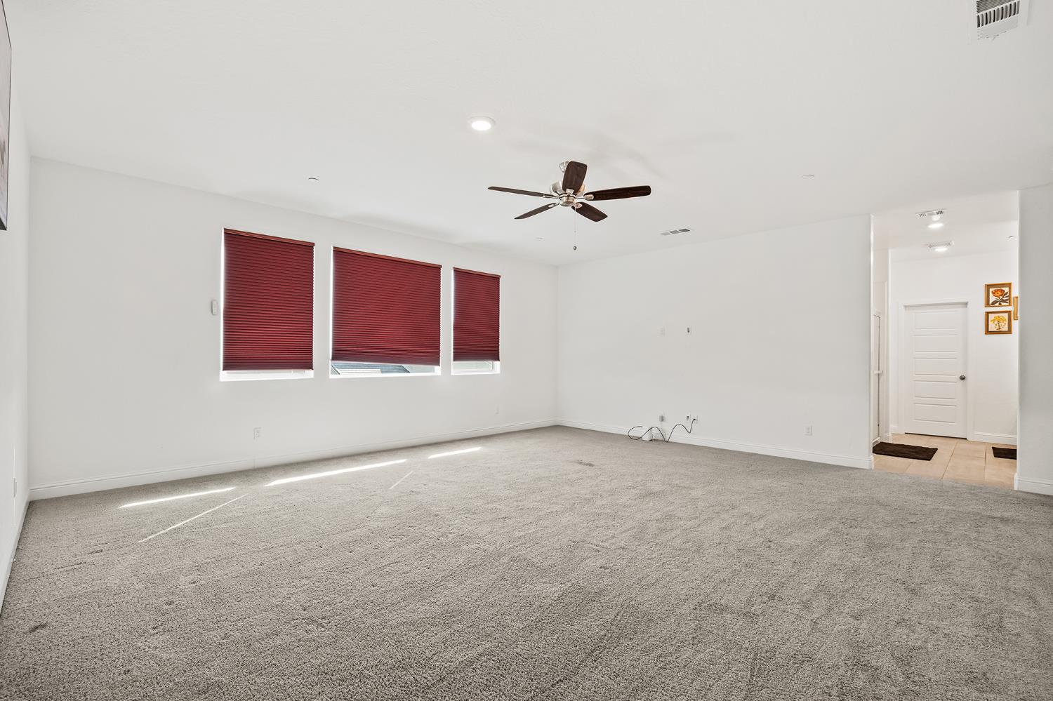 153 Boulder Drive Madera, CA 93636 - Photo 9 of 32 a view of an empty room with a ceiling fan