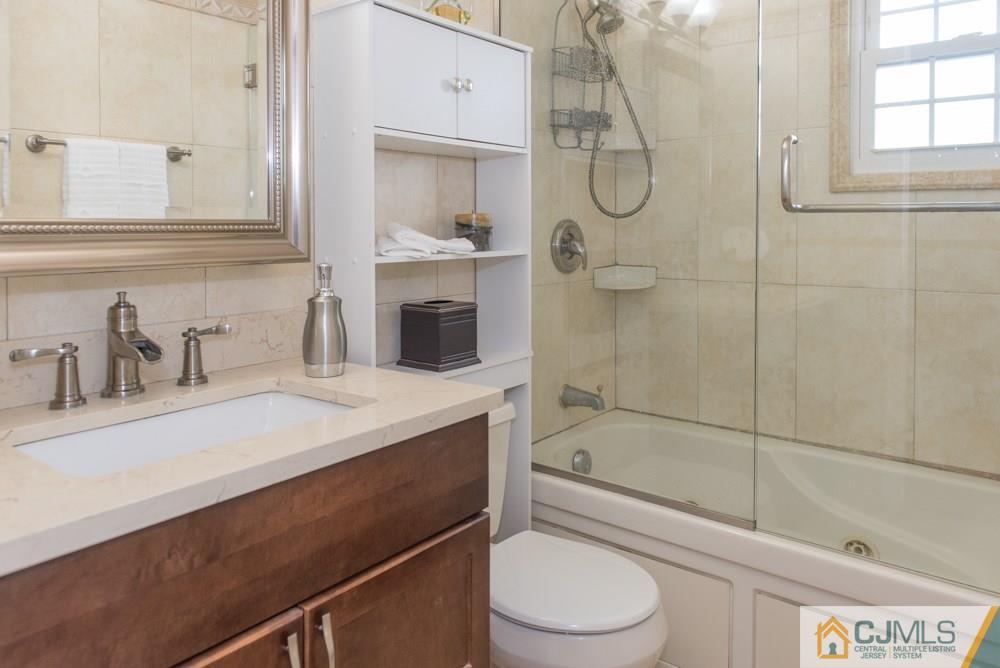 29 Mercer Road Old Bridge, NJ 08857 - Photo 14 of 24 a bathroom with a granite countertop sink a toilet and shower