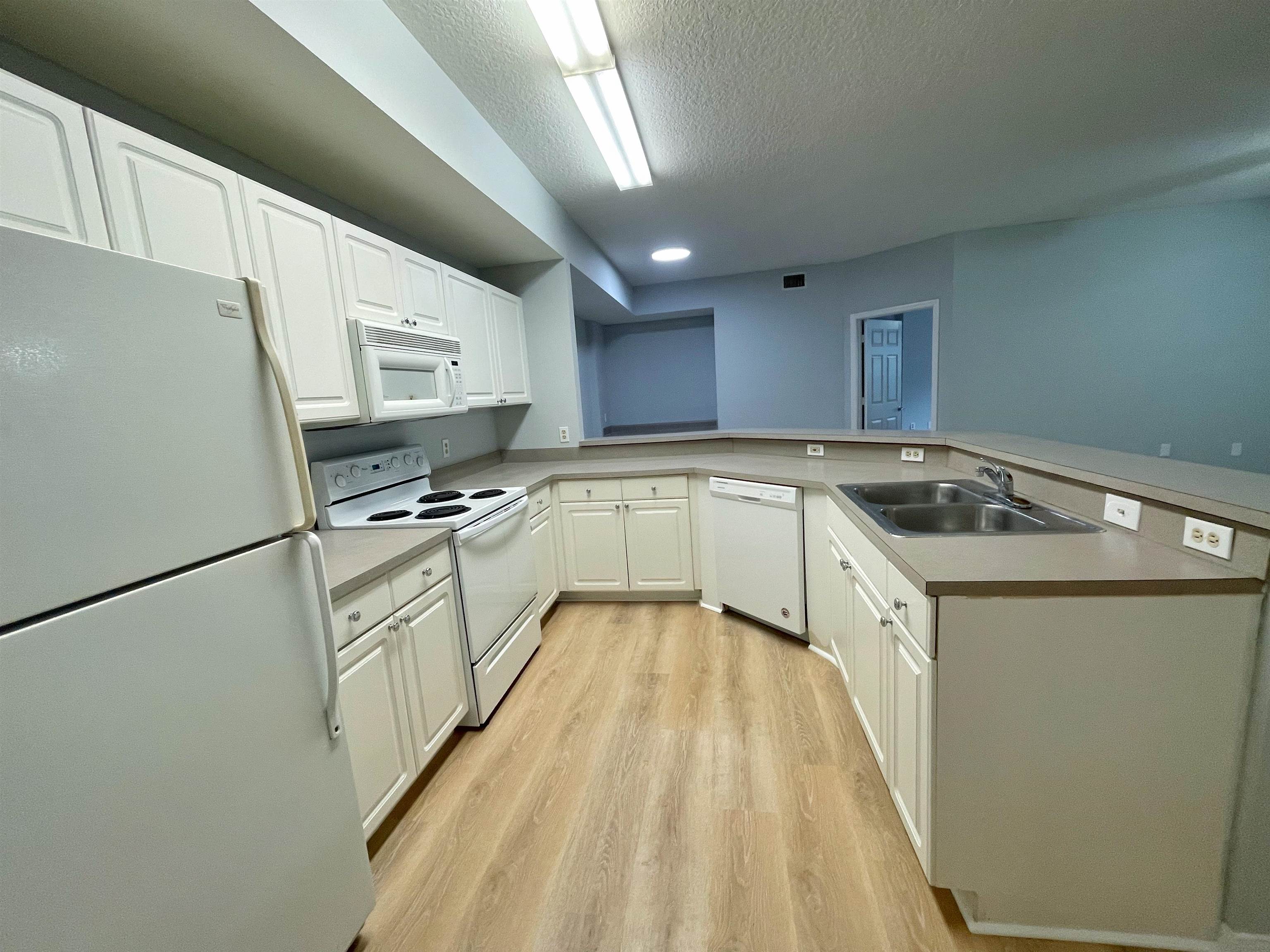 17-101 Harbour Vista Circle St. Augustine, FL 32080 - Photo 4 of 29 a kitchen with granite countertop a sink stainless steel appliances and cabinets