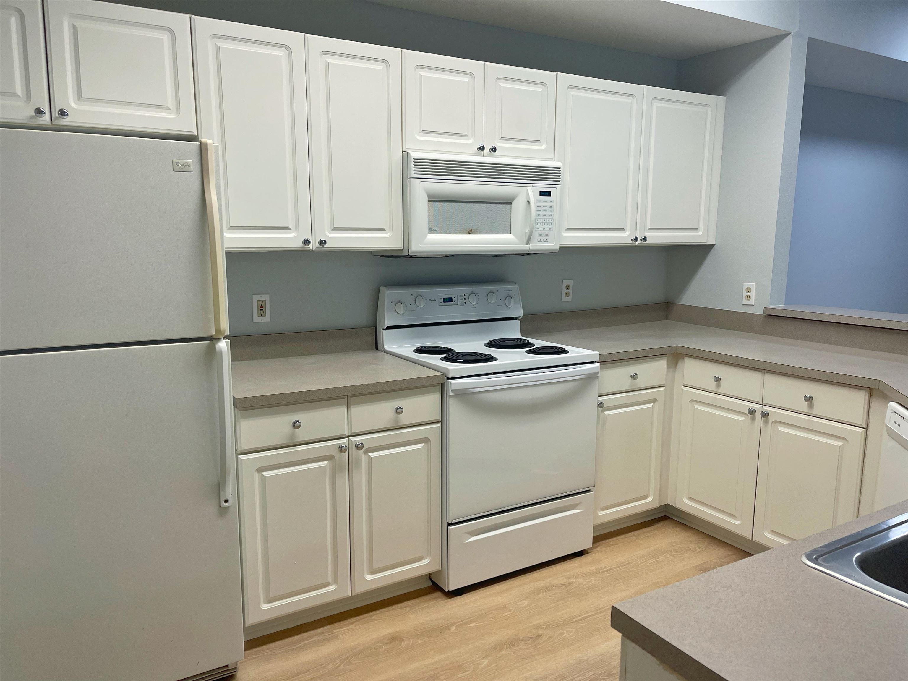 17-101 Harbour Vista Circle St. Augustine, FL 32080 - Photo 5 of 29 a kitchen with white cabinets and white appliances