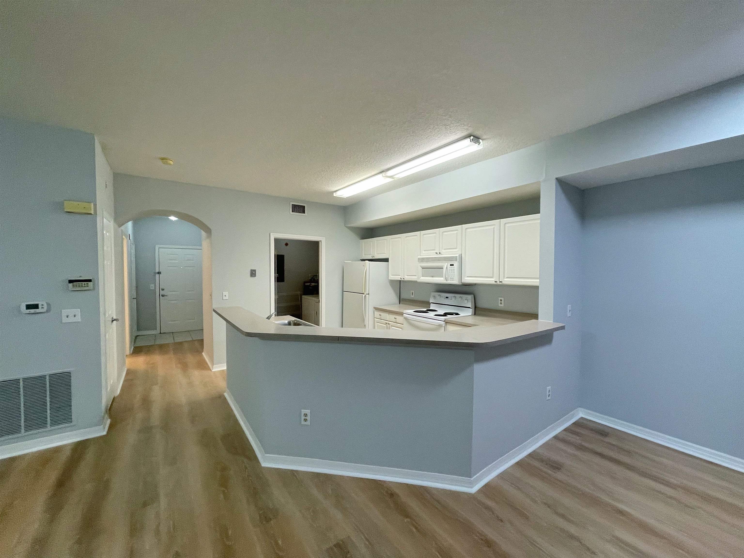 17-101 Harbour Vista Circle St. Augustine, FL 32080 - Photo 8 of 29 a living room with stainless steel appliances kitchen island a sink and wooden floor