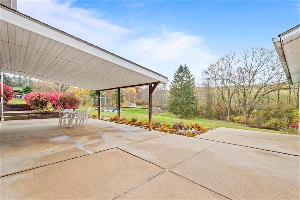 158 McConnell Road McDonald, PA 15057 - Photo 20 of 24 a view of a backyard with table and chairs under an umbrella