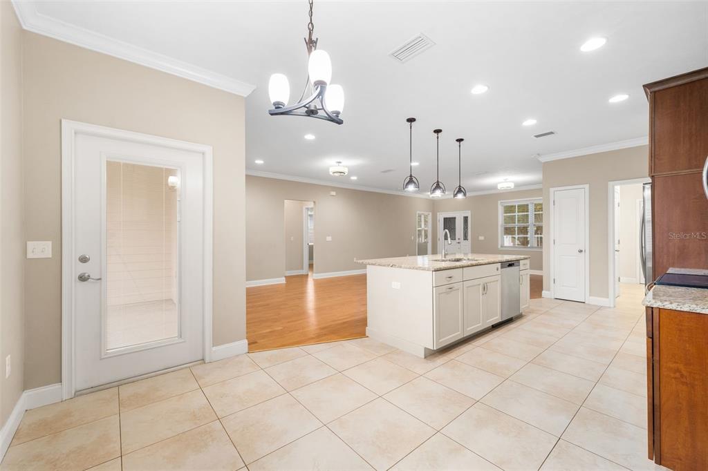 16617 Northwest 194th Street High Springs, FL 32643 - Photo 14 of 32 a large white kitchen with a large island oven a sink stainless steel appliances and cabinets
