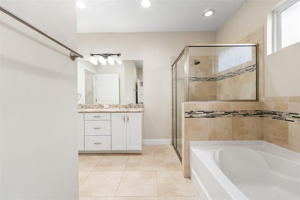 16617 Northwest 194th Street High Springs, FL 32643 - Photo 19 of 32 a bathroom with a tub a sink shower and mirror