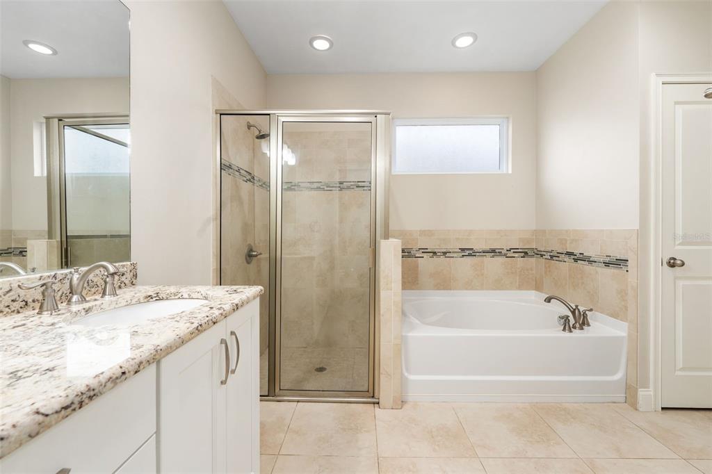 16617 Northwest 194th Street High Springs, FL 32643 - Photo 20 of 32 a bathroom with a granite countertop sink a mirror and a bathtub