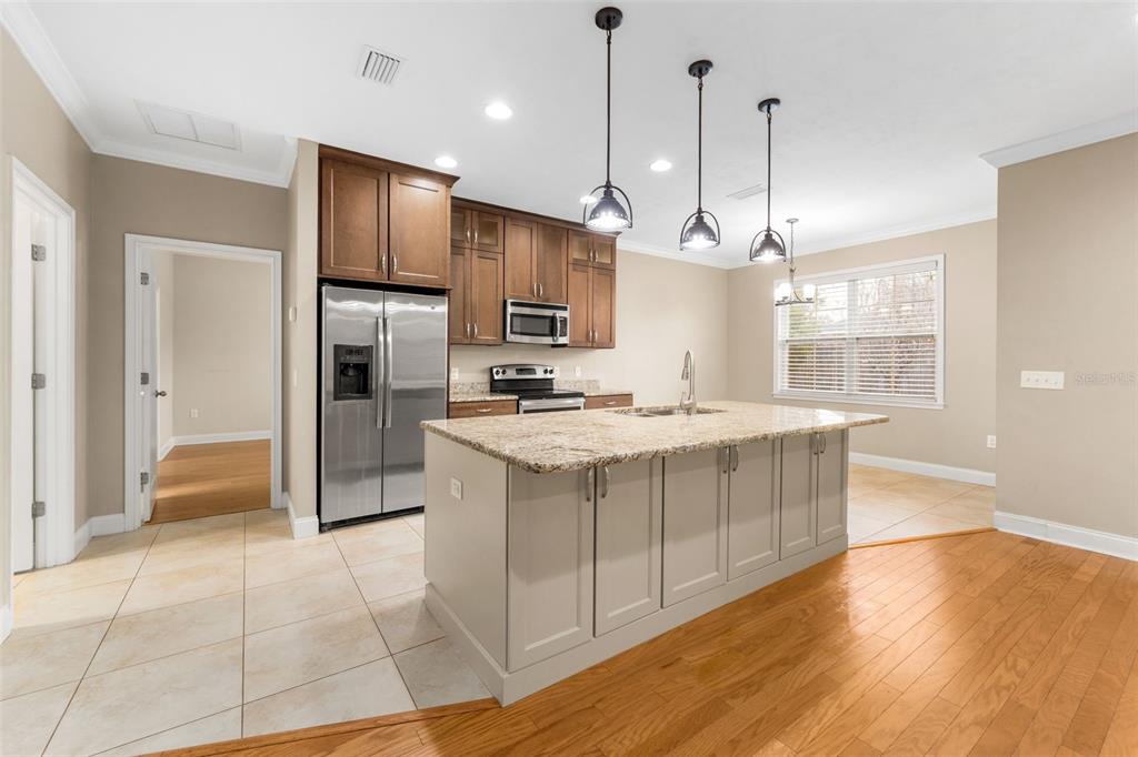 16617 Northwest 194th Street High Springs, FL 32643 - Photo 10 of 32 a kitchen with stainless steel appliances granite countertop a refrigerator a sink a stove and a wooden floors
