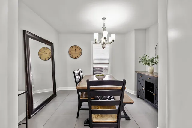 a view of a dining room with furniture and chandelier