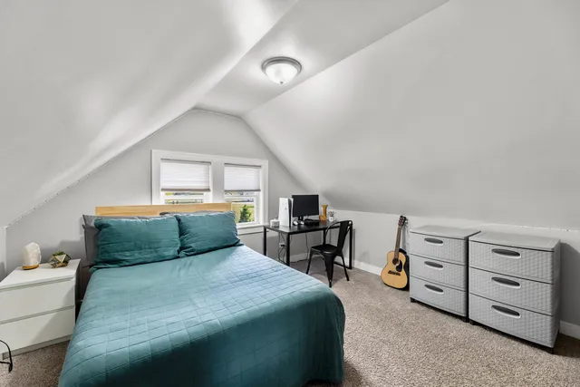 a bedroom with a bed and a dresser