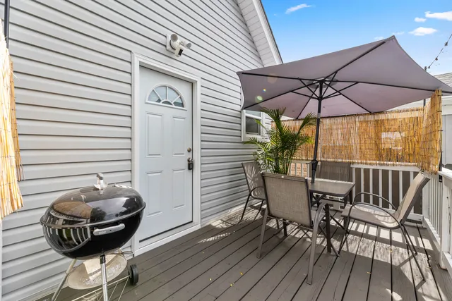 a view of a balcony with furniture and wooden floor