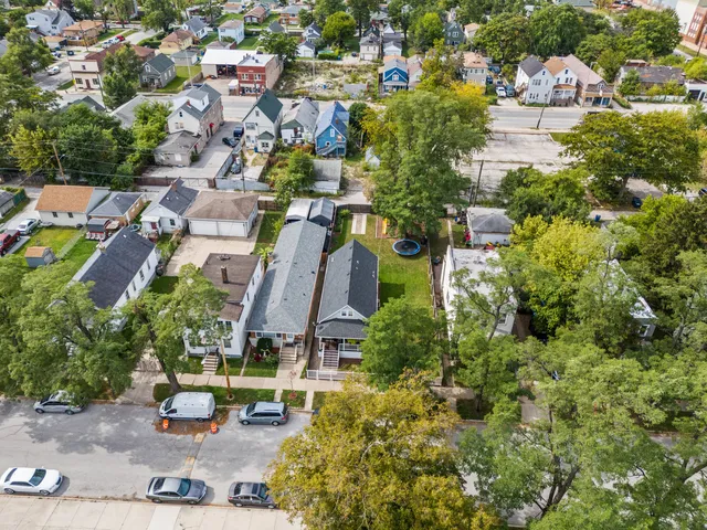 an aerial view of multiple houses with yard