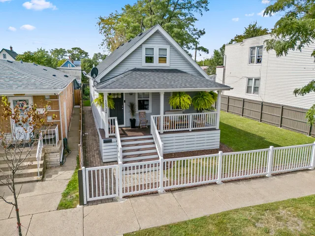 a front view of a house with iron fence