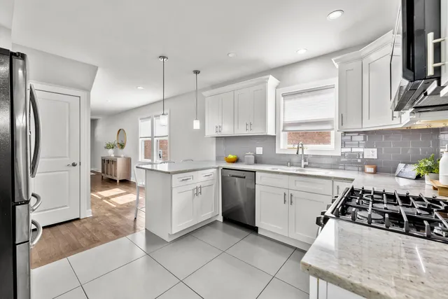 a kitchen with a stove a sink and a refrigerator