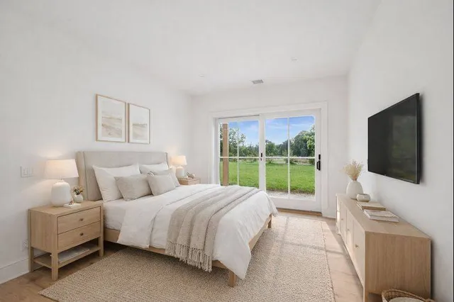 a bed room with a bed and a television