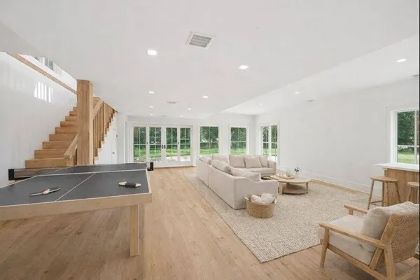 a living room with furniture and large windows