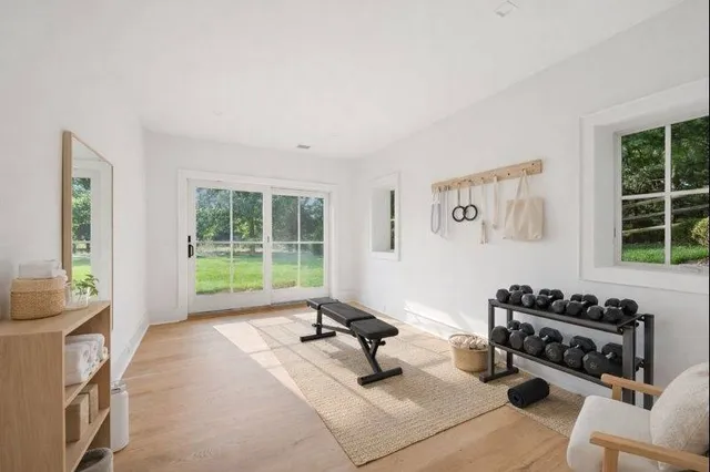 a living room with furniture a flat screen tv and a window