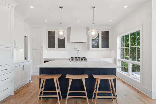a kitchen with a table chairs sink and cabinets