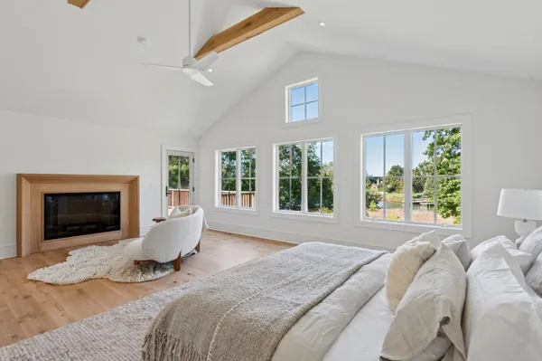 a bed sitting in a bedroom next to a window with a chandelier