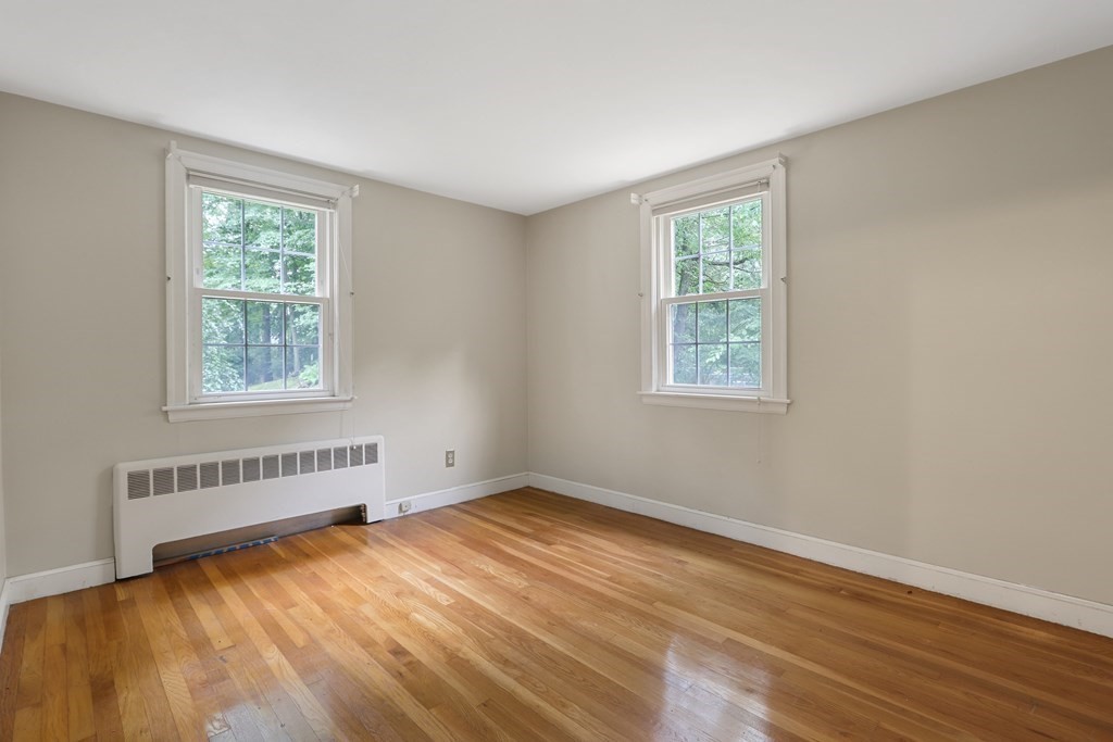 21 Cutler Drive Ashland, MA 01721 - Photo 13 of 34 a view of an empty room with wooden floor and a window