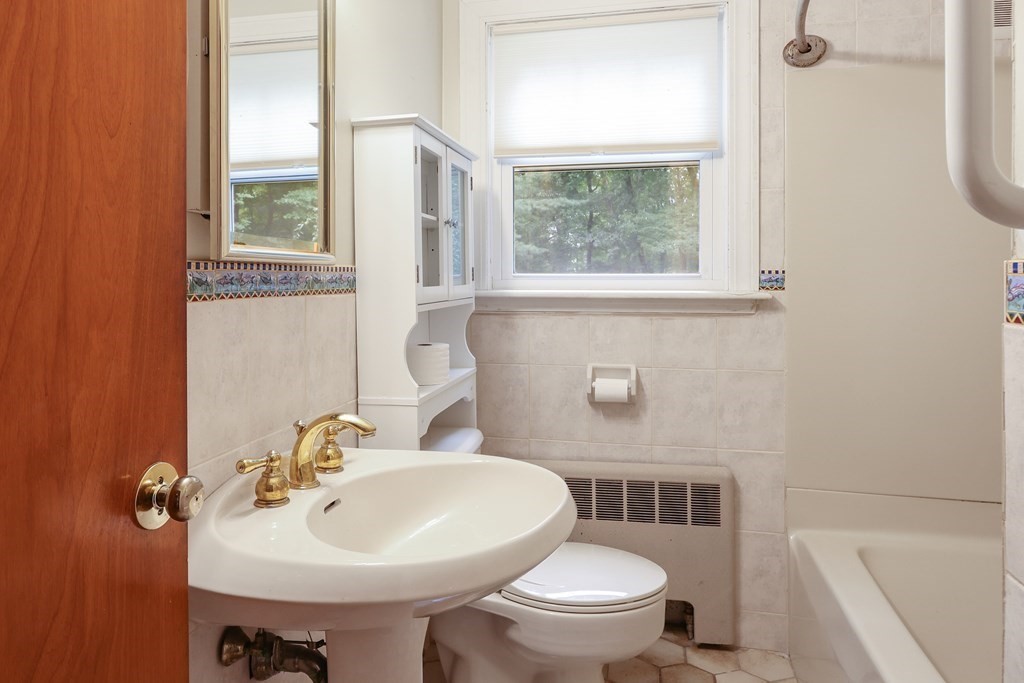 21 Cutler Drive Ashland, MA 01721 - Photo 15 of 34 a bathroom with a sink a toilet and a mirror