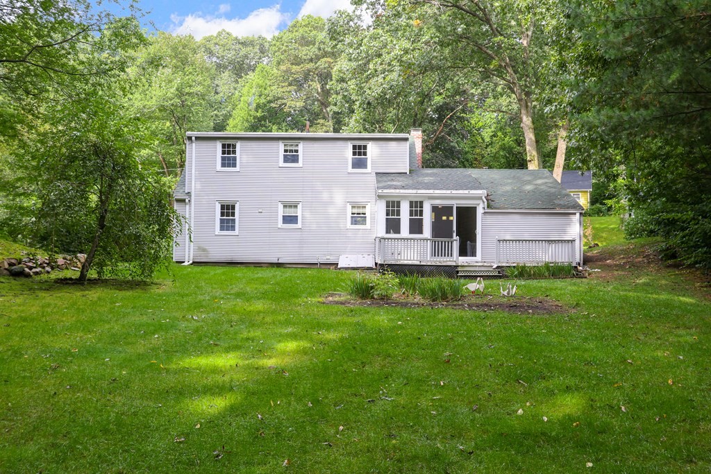 21 Cutler Drive Ashland, MA 01721 - Photo 30 of 34 a view of a house with a backyard and a garden