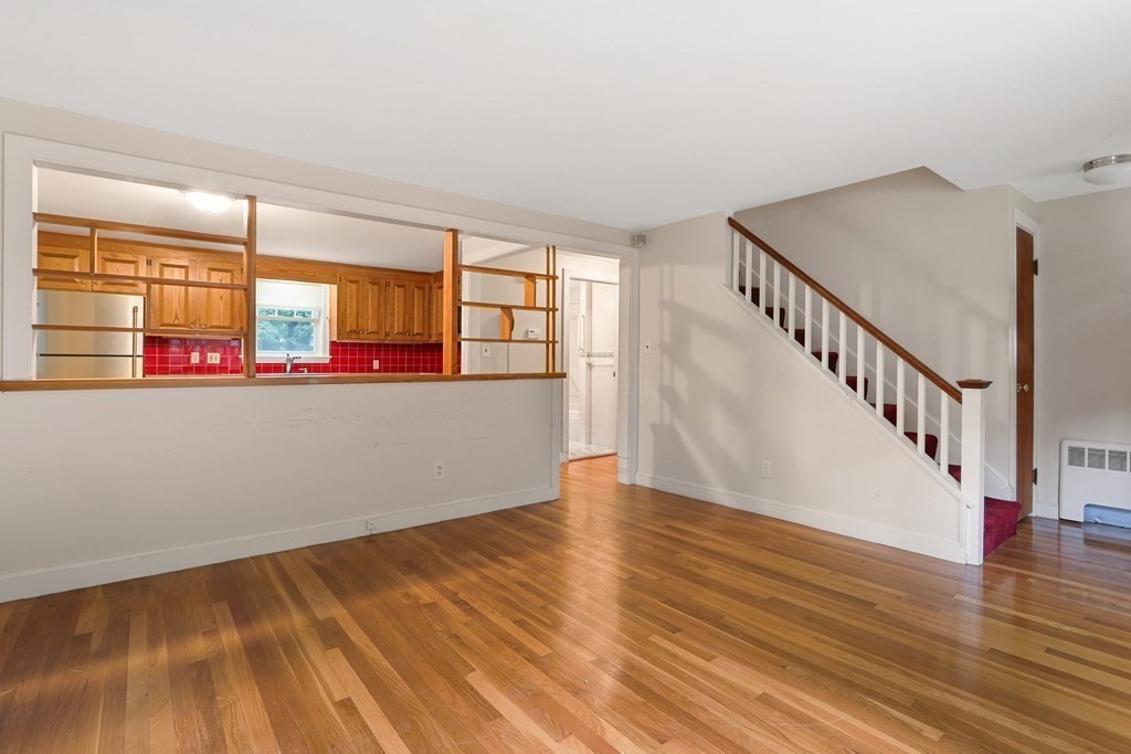 21 Cutler Drive Ashland, MA 01721 - Photo 6 of 34 a view of a room with wooden floor and windows