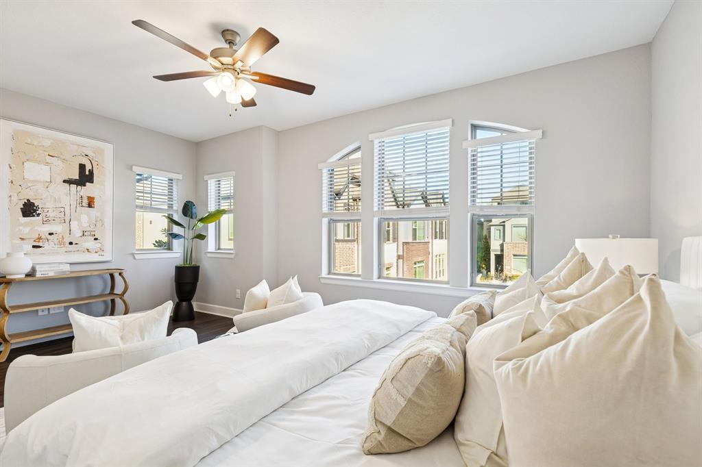 7119 Amber Grove Dallas, TX 75231 - Photo 17 of 30 a bedroom with a bed and a large window