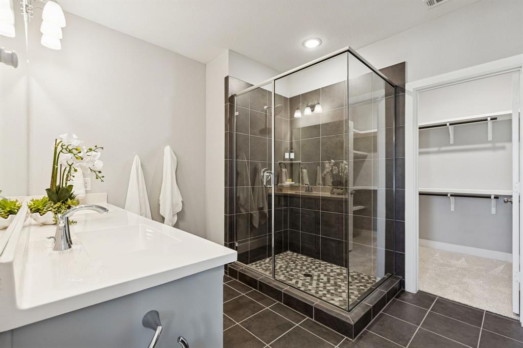 7119 Amber Grove Dallas, TX 75231 - Photo 18 of 30 a bathroom with a shower sink and mirror