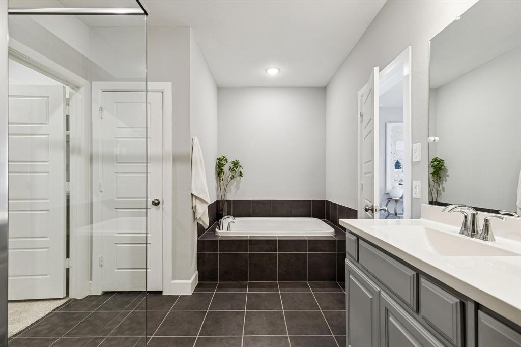 7119 Amber Grove Dallas, TX 75231 - Photo 20 of 30 a bathroom with a sink a toilet and shower