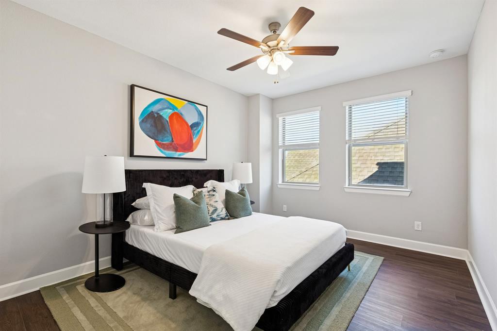 7119 Amber Grove Dallas, TX 75231 - Photo 22 of 30 a bedroom with a bed and a painting on the wall