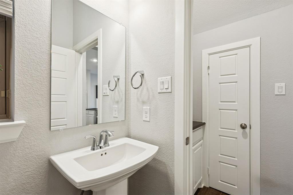 7119 Amber Grove Dallas, TX 75231 - Photo 26 of 30 a bathroom with a sink and a mirror