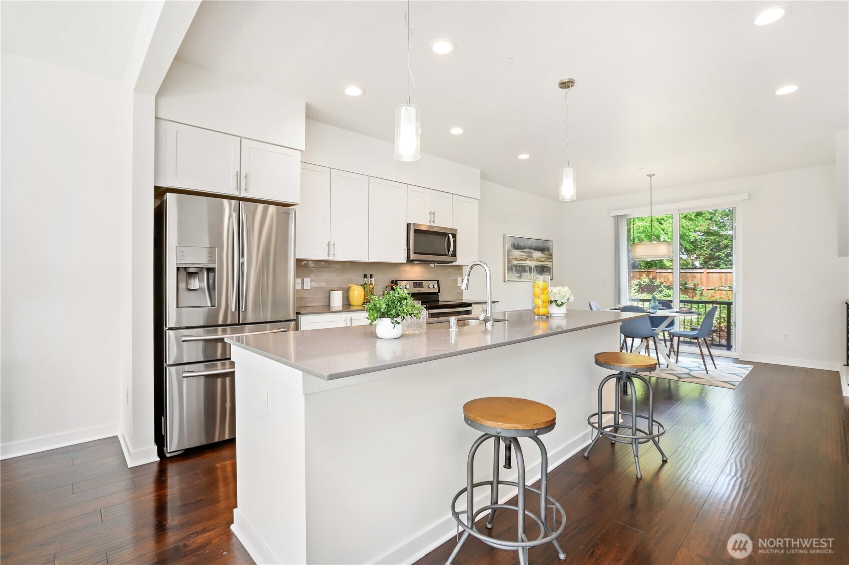 14913 48th Avenue West, Unit C4 Edmonds, WA 98026 - Photo 11 of 32 a kitchen with stainless steel appliances a dining table chairs refrigerator and microwave