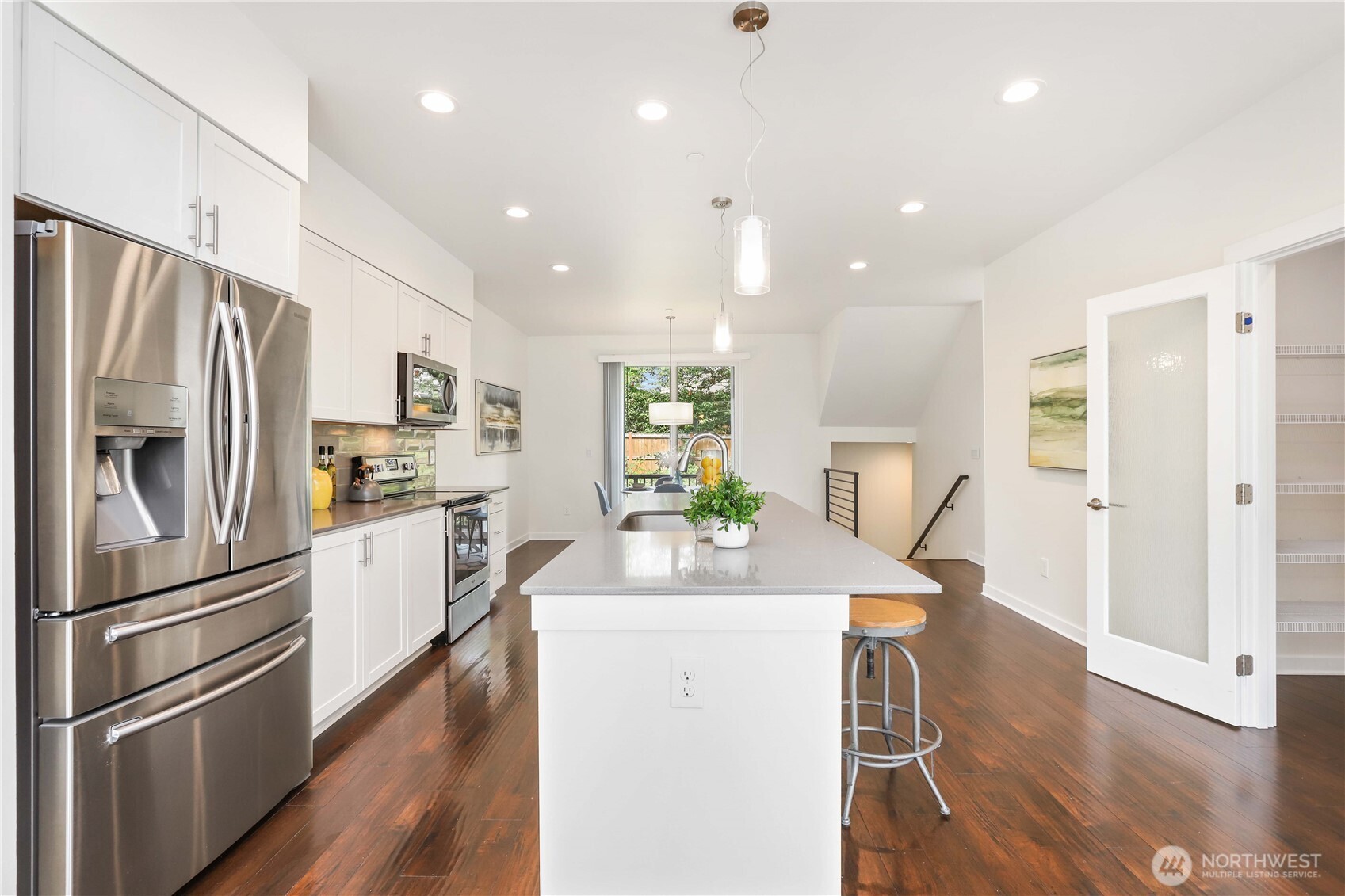 14913 48th Avenue West, Unit C4 Edmonds, WA 98026 - Photo 10 of 32 a kitchen with stainless steel appliances kitchen island granite countertop a refrigerator and a stove top oven