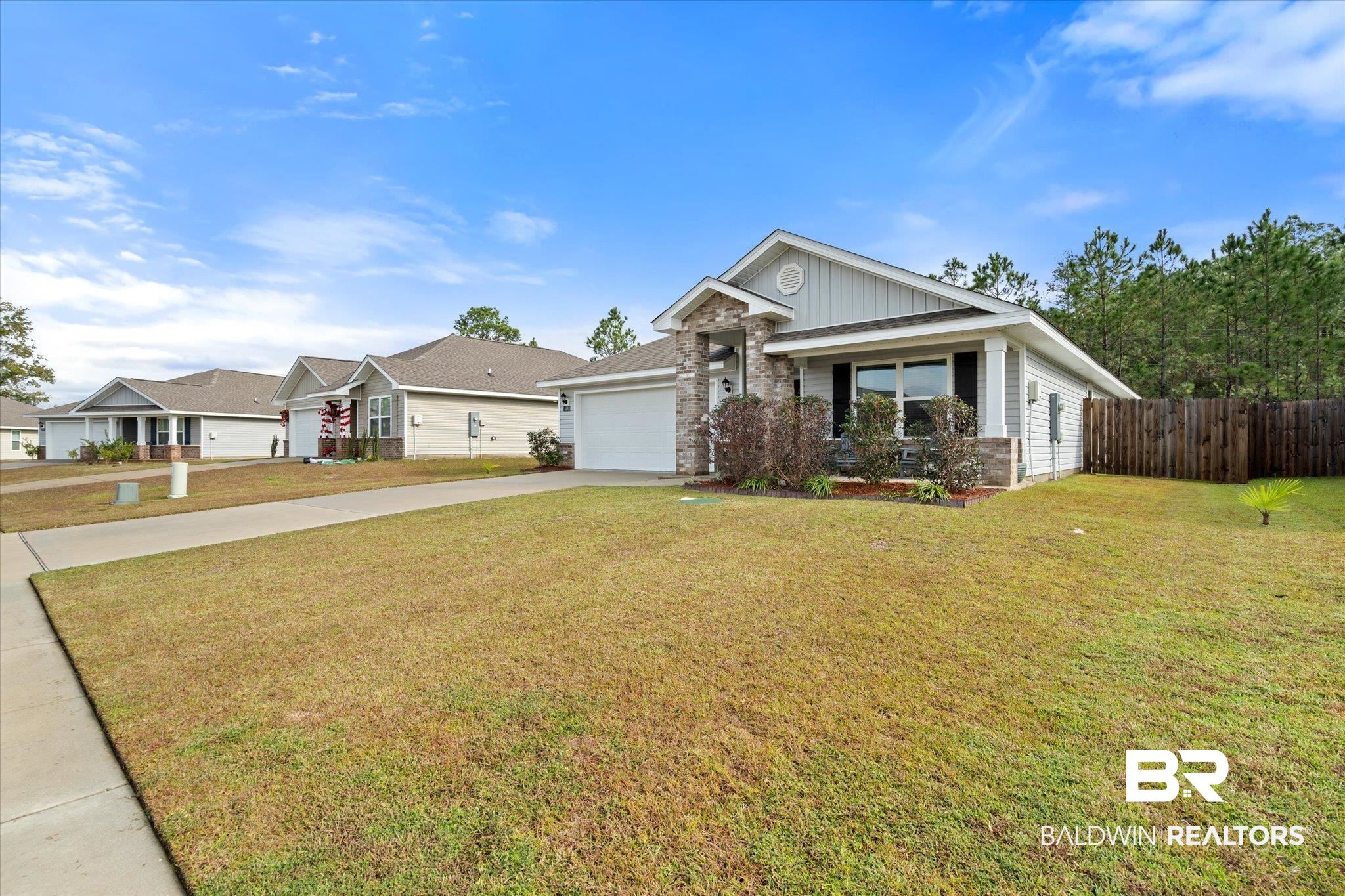446 Paget Drive East Mobile, AL 36608 - Photo 20 of 20 View of front of home featuring a garage and a front yard
