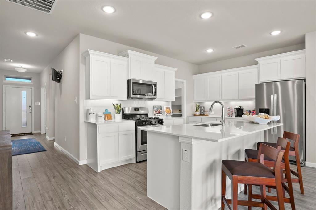 676 Poppy Lane Lavon, TX 75166 - Photo 8 of 35 Kitchen in the Masters home plan by Trophy Signature Homes – REPRESENTATIVE PHOTO
