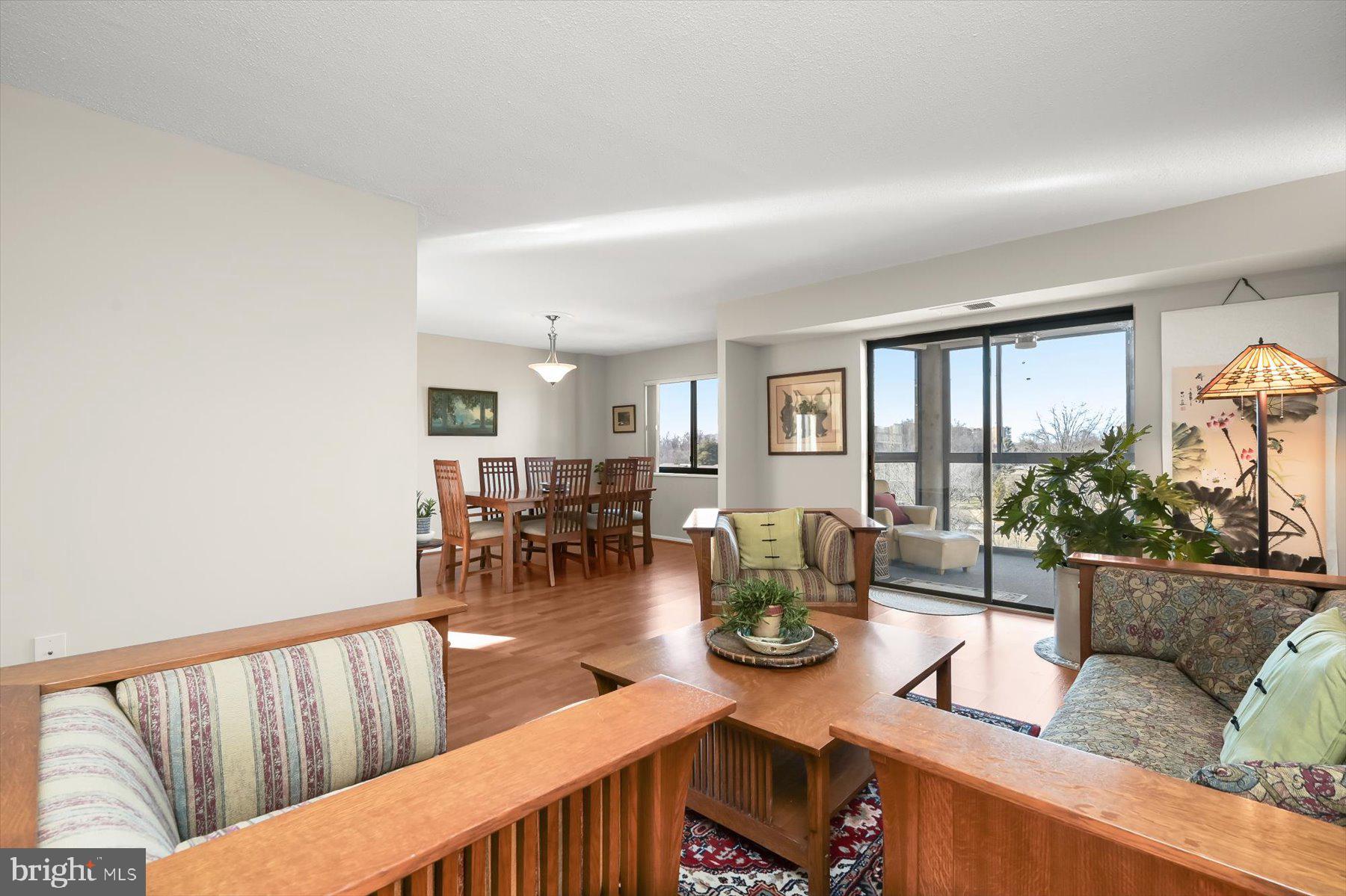 15107 Interlachen Drive, Unit 2725 Silver Spring, MD 20906 - Photo 11 of 35 Living room into dining & slider to sunroom