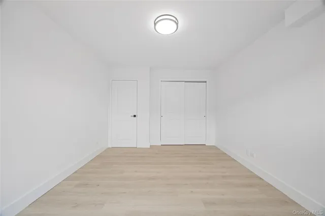a view of a room with wooden floor and window