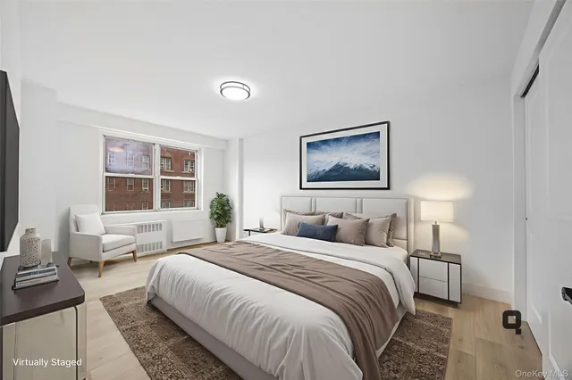 a bedroom with a large bed and a window