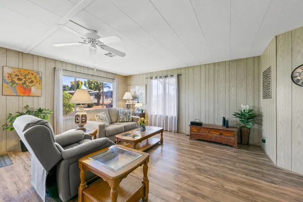 a living room with furniture and wooden floor