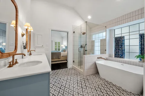 a bathroom with a sink a toilet a mirror and shower